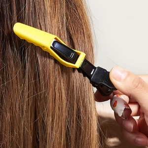 Professional yellow and black hair sectioning clips for salon styling and hair coloring