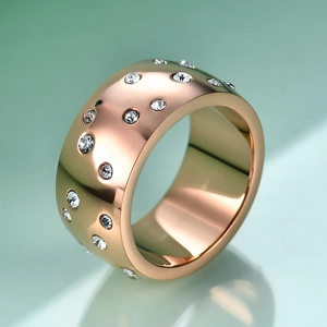 Detailed macro view of a 10mm wide rose gold stainless steel ring with scattered diamonds
