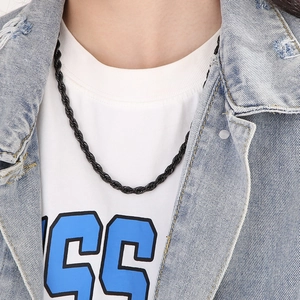 Close-up of a black twisted rope titanium steel necklace worn on a male model neckline