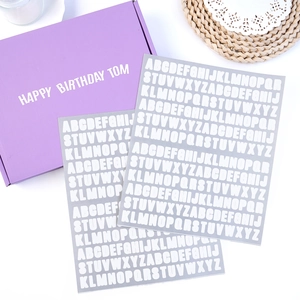 Detail of waterproof alphabet stickers with white letters on gray background for notebooks