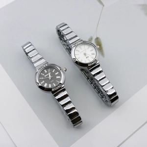 Detailed shot of two elegant quartz watches with Roman dials and rhinestone bezels