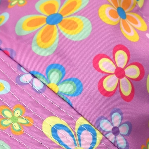 Close-up of purple canvas bucket hat with multicolor floral print and fine stitching