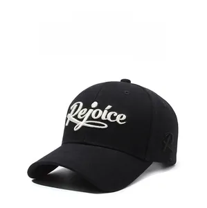 Close-up of white Rejoice embroidery on a black structured cotton baseball cap