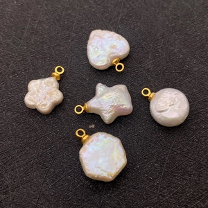 Detailed view of assorted natural freshwater pearl pendants in star and heart shapes