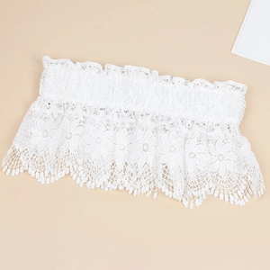 Detailed close-up of white floral lace elastic waistband featuring intricate embroidery