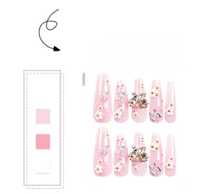 Detail of pink glitter press-on nails featuring 3D flowers and butterfly charms