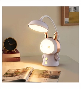 Detailed close-up of a white rabbit LED desk lamp with a flexible neck on a cozy desk