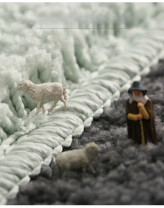 Detailed macro view of soft thickened flocked bathroom mat with green and grey plush texture