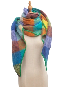 Detail of colorful plaid scarf showing soft knit texture and green stitched hem finishing