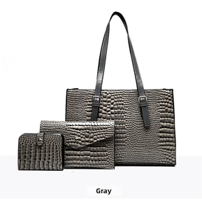 Detailed view of 3-piece grey crocodile pattern handbag set including tote and wallet