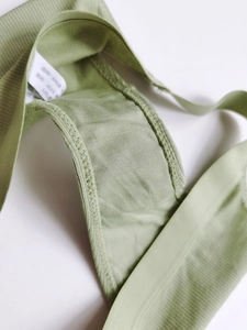 Detail view of cotton crotch lining and laundry label on light green ribbed panties