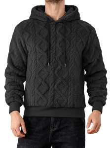 Detail of black hoodie featuring premium 3D diamond quilted texture and ribbed cuffs