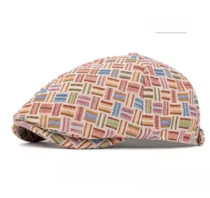 Detail of colorful jacquard plaid newsboy hat featuring textured woven fabric and pink tones