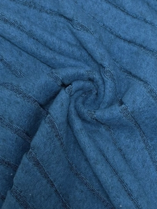 Detail of dark blue ribbed fabric showing soft knit texture and vertical stripe patterns