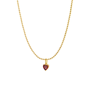 Detail of a small red heart zircon pendant on a gold bead chain necklace with a white background