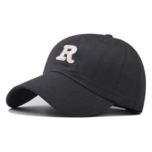 Close-up of deep gray cotton baseball cap featuring a detailed white letter R embroidery
