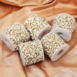 Five rolls of white shell bead chains with golden links for DIY jewelry making