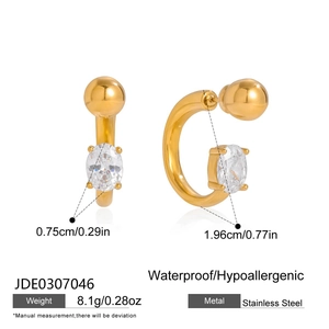 Vue détaillée des boucles d'oreilles créoles C dorées avec zircone ovale et fermoir à vis