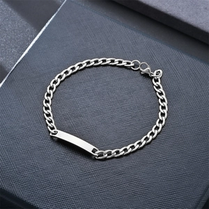 Cuban link stainless steel couple bracelet with blank ID plate on blue textured box