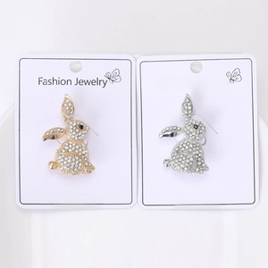 Close-up of gold and silver rhinestone rabbit brooches on fashion jewelry display cards