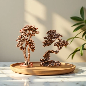Detailed close-up of two vintage brass pine tree ornaments on a wooden tray with soft lighting