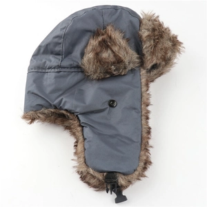 Detail of waterproof winter trapper hat with dark grey shell and brown faux fur lining