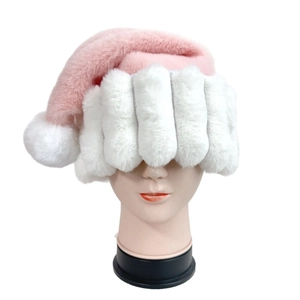 Detail of plush pink Santa hat featuring thickened white faux fur trim and pompom detail