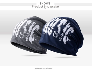 Detail of dark grey and navy blue knit beanies featuring a stylish white MUSIC graphic print