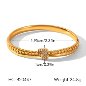 Close-up of 18k gold plated stainless steel twisted bangle with CZ inlay and dimensions