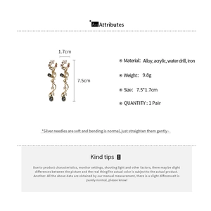 Detail view of crystal butterfly floral drop earrings with length and material specs