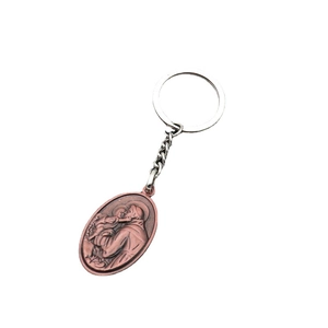 Retro religious key chain with antique copper saint relief pendant on white background