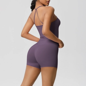 Detail of purple yoga romper showing cross-back thin straps and bodycon fit design
