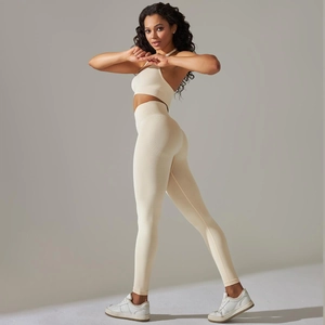 Detail of beige ribbed seamless yoga set featuring halter sports bra and high waist leggings