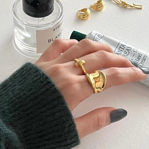 Minimalist 925 silver golden knot and textured ring set shown in a lifestyle scene