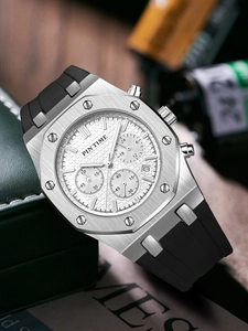 Macro shot of silver octagonal chronograph watch with white textured dial and black strap