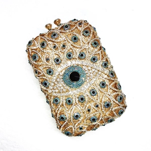 Golden crystal clutch with evil eye design encrusted with sparkling rhinestones and gems