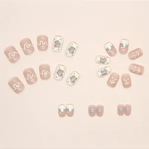 Pink and creamy yellow press-on nails set with smiley faces and stars patterns