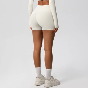 Macro shot of high-waist cream yoga shorts highlighting ergonomic back seams for lifting