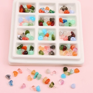 Irregular acrylic beads in assorted colors for DIY bracelet making on white tray