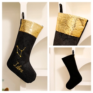 Black and gold Christmas stocking featuring Libra zodiac pattern and gold sequins