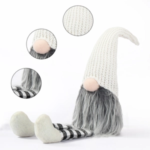 Detail of knitted Christmas gnome with long checkered legs and grey faux fur beard