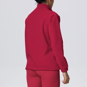 Detail view of red fleece sports jacket collar and textured warm fabric for women