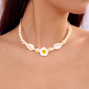 Detail of bohemian choker with white flower, natural shells and braided cord on neck