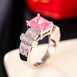 Macro detail of square pink gemstone ring with micro-pave setting on silver band