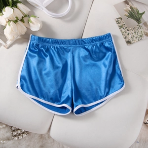 Flat lay of royal blue satin shorts with white contrast trim on a white textured background