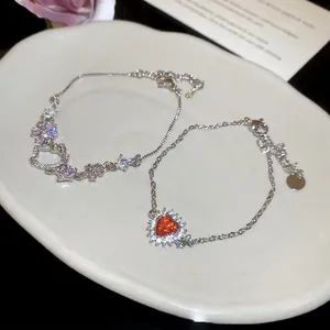 Elegant silver-toned bracelet set featuring Hello Kitty charms and red heart zircon stones