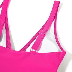 Detail of adjustable fuchsia swimsuit strap with silver buckle and reinforced stitching