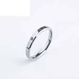 Minimalist silver stainless steel ring with a single embedded zircon at a 45-degree angle
