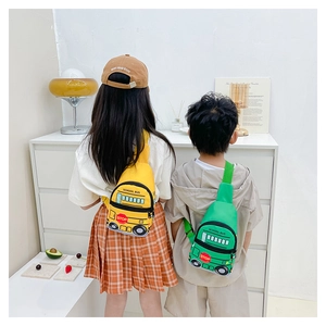 Kid back view wearing yellow school bus chest bag with adjustable strap and zip