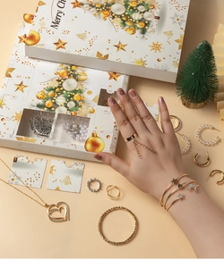 Detailed view of Christmas advent calendar box with festive jewelry pieces and pearls
